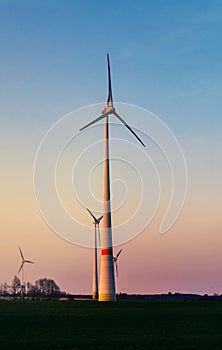 Windmill at Sunset . Wind turbines farm .