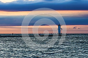 Windmill in Swinoujscie by the Baltic sea by sunset with pink an