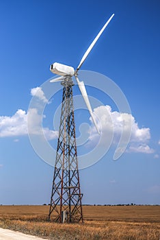 Windmill to generate electricity on a bright summer day