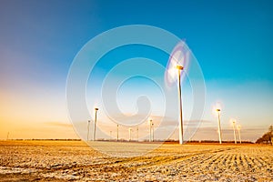 Windmill turbines for electric production against blue sky