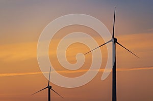 WIndmill turbines, energy generators against spectacular sunset