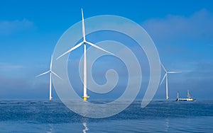 Windmill turbines at sea a huge winmill park in the Netherlands during winter