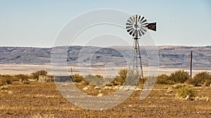 Windmill and water storage tank along Highway 90 just outside of Marfa, Texas.