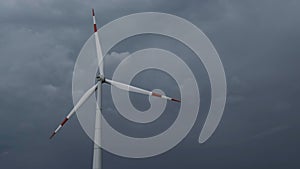 Windmill or wind turbine on wind farm in rotation