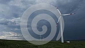 Windmill or wind turbine on wind farm in rotation