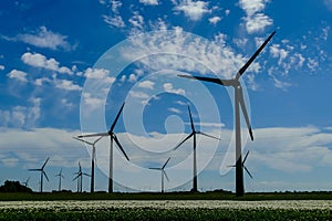 Windmill wind turbines in the field