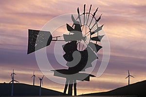 Windmill and wind turbines at sunset on Route 580 in Livermore, CA photo