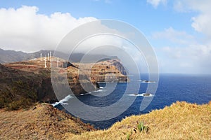 Windmills on abrupt coast of ocean