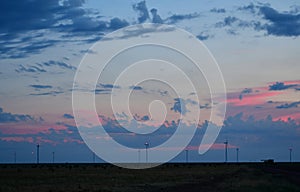 Windmills against a rainbow evening sky