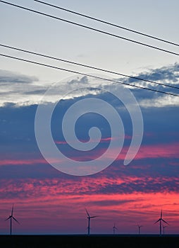 Windmills against a rainbow evening sky