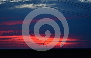 Windmills against a rainbow evening sky