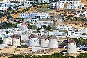 Windmills and buildings on sunny day in summer, island of Mykonos, Greece