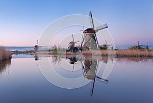 Windmills and clear blue sky at sunrise in Kinderdijk, Netherlands