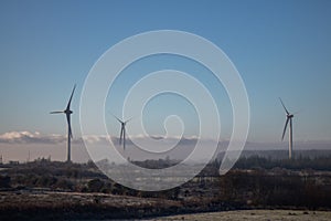 windmills on a cold frosty foggy day