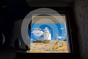Windmills of Consuegra seen from inside a window of another mill,