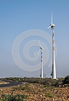 Windmills for electricity generation  near a highway in Gujrat, India.