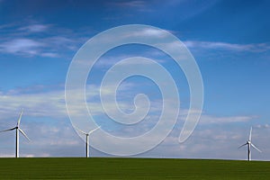 Windmills for green energy in the field