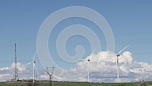 Windmills harnessing clean energy in a windfarm, Power generation from sustainable wind turbines, Windmill farm producing