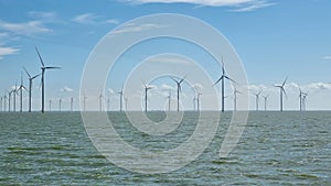 Windmills on large body of water