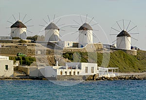 Windmills lined up in a row on the island of Mykonos, Greece.