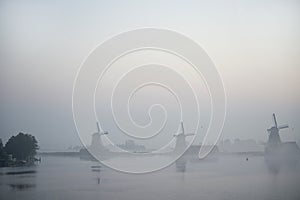 Windmills in morning fog the Netherlands