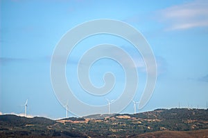 Windmills on mountain with blue sky