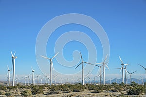 Windmills with mountains and clear blue sky on a sunny day landscape