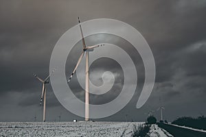 windmills near the asphalt road in winter