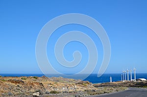 Windmills near the blue sea