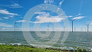 Windmills overlooking large body of water