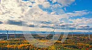The Windmills park of Paldiski. Wind turbine farm near Baltic sea. Autumn landscape with windmills, orange forest and