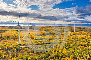 The Windmills park of Paldiski. Wind turbine farm near Baltic sea. Autumn landscape with windmills, orange forest and