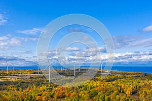 The Windmills park of Paldiski. Wind turbine farm near Baltic sea. Autumn landscape with windmills, orange forest and