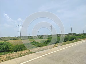 Windmills placed near the coastal highway to generate clean and green electricity.