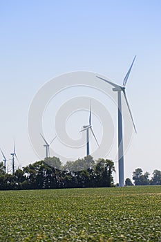 Windmills power plant in rural landscape. Wind turbine farm for electric power production. Windmills for electric power production