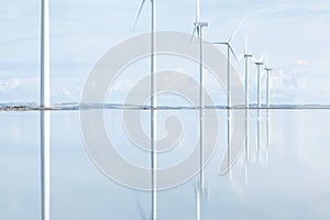 Windmills reflecting in danish Fjord