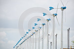 Windmills for renewable electric energy production in windmill farm.