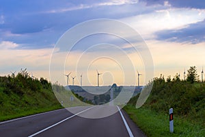 Windmills rotate blades over farmland