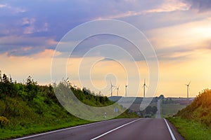 Windmills rotate blades over farmland