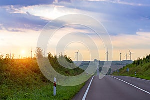 Windmills rotate blades over farmland