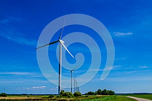 Windmills in a row from the ground