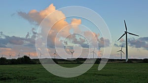 Windmills at sunset. Scene in Jylland, northern Denmark.