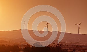 Windmills at the sunset time in the mountains