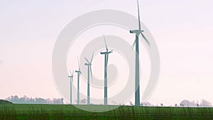 Windmills turbines on field