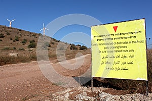 Windmills and warning sign in the Golan area in Israel