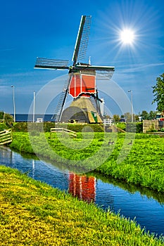 Windmills and water canal in Kinderdijk, Holland or Netherlands