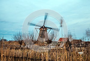 Windmills and water canal on sunset in Kinderdijk, Holland