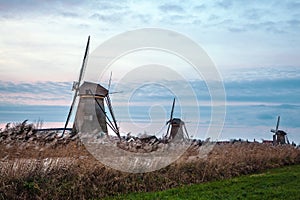 Windmills and water canal on sunset in Kinderdijk, Holland