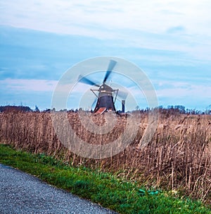 Windmills and water canal on sunset in Kinderdijk, Holland