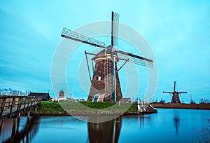 Windmills and water canal on sunset in Kinderdijk, Holland